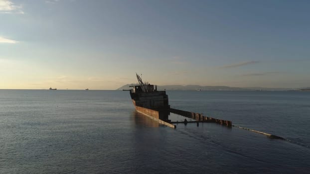 Aerial view of the ship washed ashore. Shot. Top view of an abandoned old and rusty shipwreck on a stormy day.