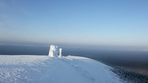 Aerial winter view of giants of the Manpupuner Plateau, Komi Republic. Clip. Helicopter flying above snow covered hills