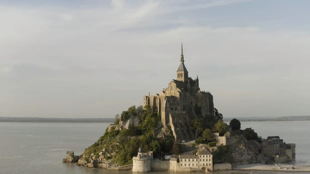 Beautiful Mont Saint Michel cathedral located on the island, Normandy, Northern France, Europe. Panoramic view of famous historic tidal island with stunning castle.