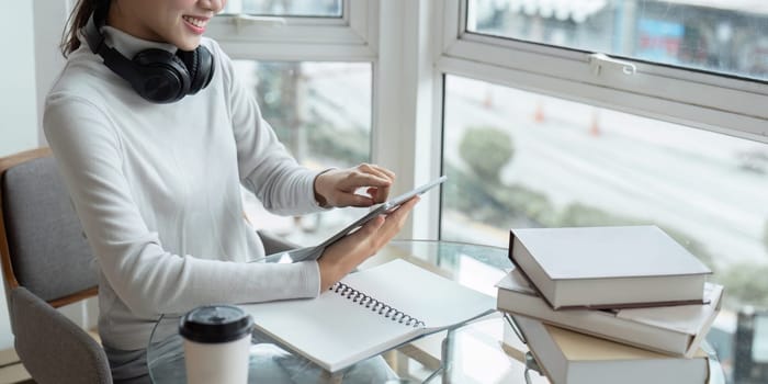 Young woman enjoy of resting relax and using tablet near window at home.