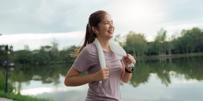 Women runner wearing sport cloths jogging in morning at park. Active morning.