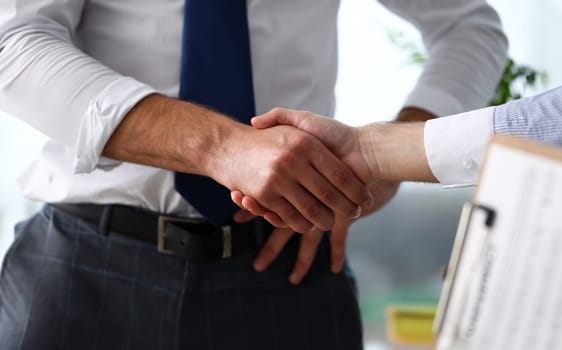 Man in suit and tie give hand as hello in office closeup. Friend welcome mediation offer positive introduction thanks gesture summit executive approval motivation male arm strike bargain