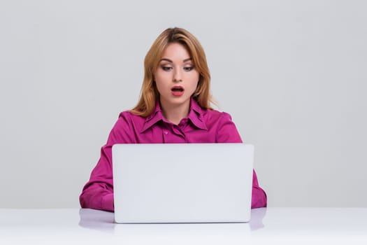 Young businesswoman working at laptop computer. she was surprised, prints and looking at monitor