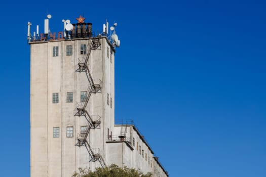 telecommunication antennas on top of old soviet elevator tower, letters means labor