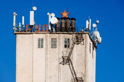 telecommunication antennas on top of old soviet elevator tower, letters means labor