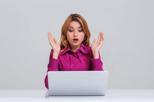 Young businesswoman working at laptop computer. she was surprised, prints