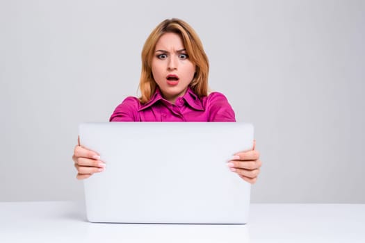 Young businesswoman working at laptop computer. she was surprised, prints and looking at monitor