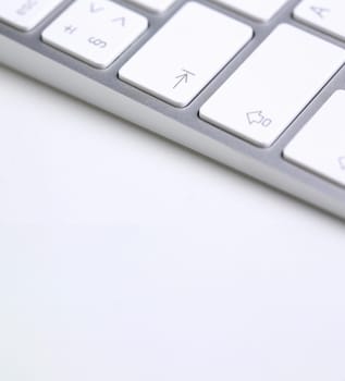 Silver keyboard with white key push button background closeup