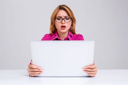 Young businesswoman working at laptop computer. she was surprised, prints and looking at monitor