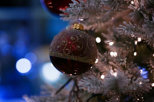 Red ball hanging on the christmas tree background