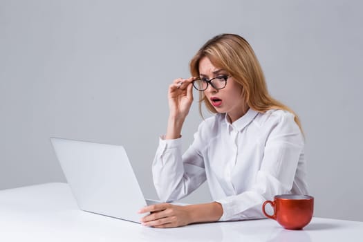 Young businesswoman working at laptop computer. she was surprised, prints and looking at monitor