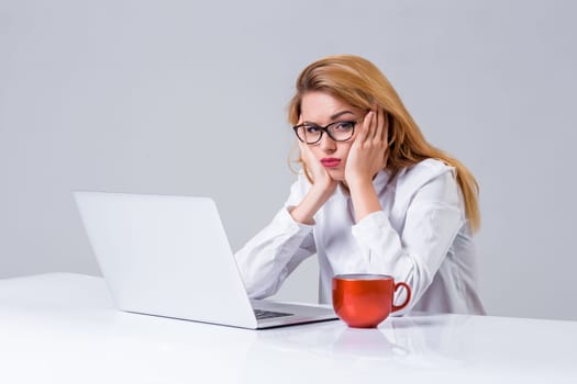 Young businesswoman working at laptop computer. she was tired, prints and looking at monitor