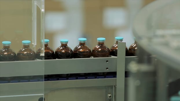 Pharmaceutical industry. Production line machine conveyor at factory with bottles. pharmaceutical production of liquid pharmaceuticals HD