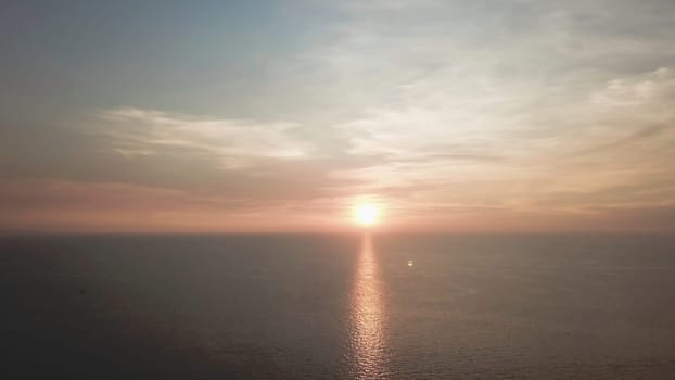 Panorama of beautiful sunset on the ocean. Video. View of sunset seascape in the middle of the ocean. Aerial.