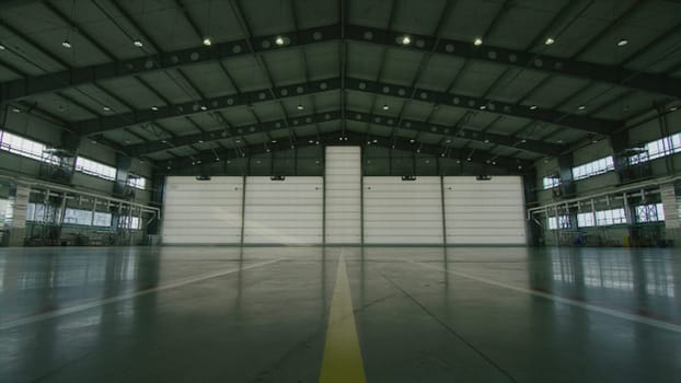 Roll or shutter door in airport hangar. Shutter door or roller door and concrete floor inside factory building for industry background. corrugated metal doors of Commercial Building HD