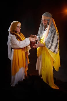 A couple in love or a married couple in stylized Eastern clothing from Israel, Palestine, Iran, Pakistan together. Tender photo session in the style of the Middle East and the Bible