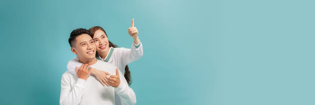 Attractive woman is indicating direction and pointing with index finger the way