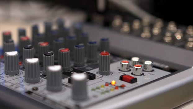 Close-up of mixing console. Stock. Close up multi color buttons of sound mixer console, shallow depth of field DOF .