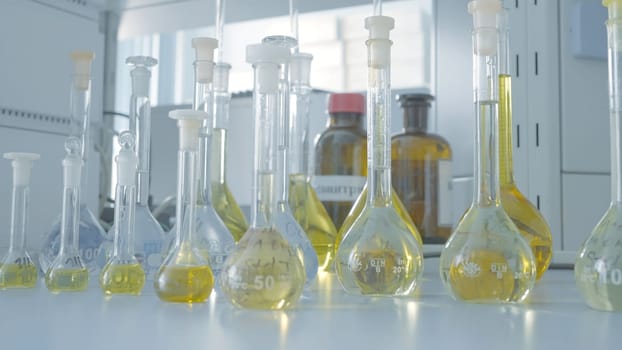 Laboratory test tubes for analysis. Action. Laboratory flasks and test tubes with liquid for analysis and experiments. Laboratory work with test tubes and liquid.