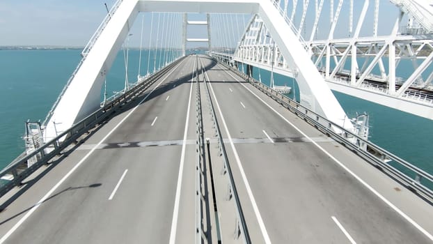 A huge bridge is a bird's-eye view. Action. A long new bridge built for the movement of transport over the big sea. High quality 4k footage