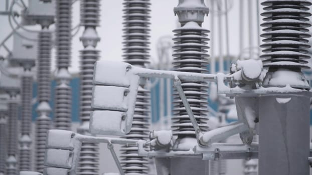 Switchgears and switches in a power plant with steel structure. Power plant detail, high voltage isolation. Voltage transformers at the power plant.