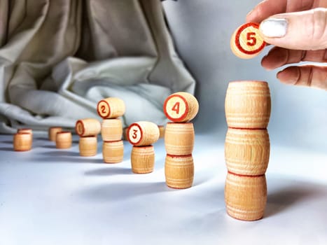 Small wooden barrels with numbers built in columns. The concept of duration and ways to achieve the goal. The sequence of actions to obtain the effect and result
