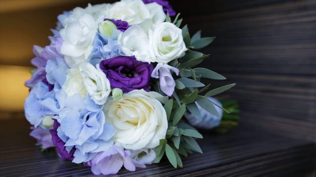Perfect bouquet of creme luxurious roses for wedding, birthday or Valentine's day. Black old wooden background, top view. the bride's bouquet on black wood. Blue and white and pink roses HD
