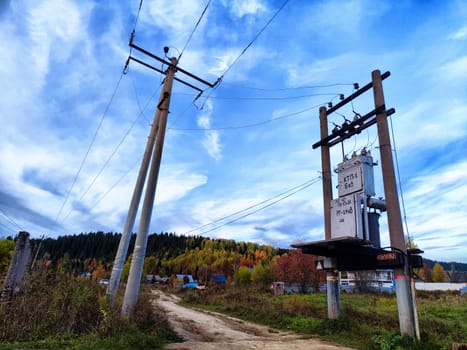 Old power poles and the sky with clouds in the background. Electric lines, towers, wires in landscape