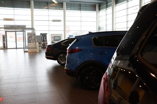 Kazan, Russia - November 25, 2022: Cars in showroom of dealership Kia in Kazan in Russia. Partial focus