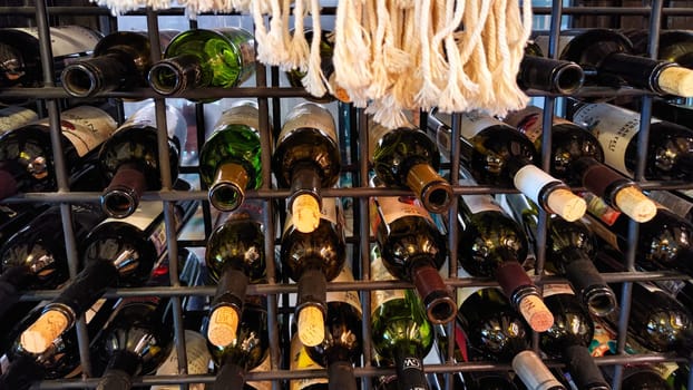 Kirov, Russia - May 08, 2023: Wine bottles stacked on wooden racks