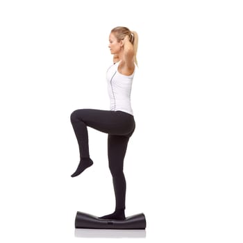 Woman, balance and mat in studio for fitness, pilates or workout for healthy body, wellness or exercise. Person, face and yoga in sportswear for physical activity on mock up space or white background.