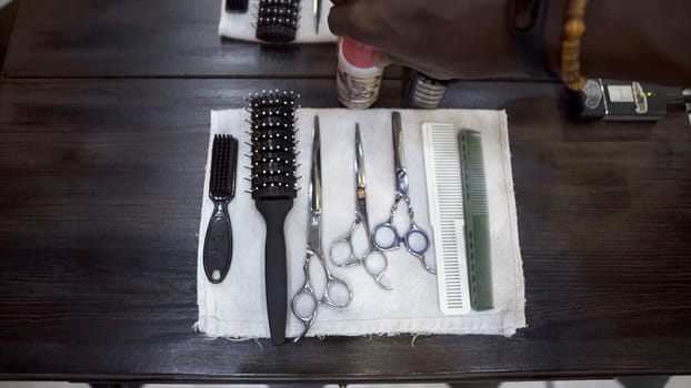 Close-up of barber set. Close-up of hands of hairdresser preparing professional set of hairdressing tools for cutting. Concept of hairdressing tools.