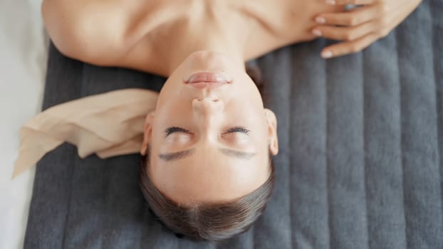 A woman after cosmetology services. Action. A person with bright blue eyes touches her body and face with her hands after massages and face masks