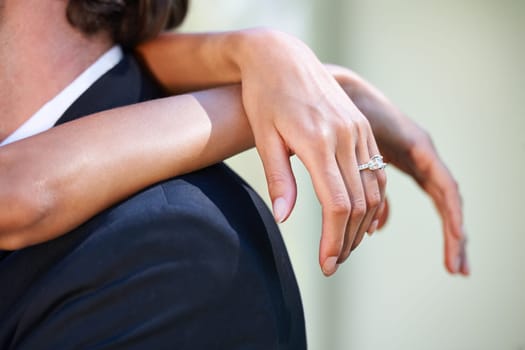 Love, wedding day and hands of bride hug groom in celebration of union, commitment or event closeup. Marriage, ceremony and finger jewellery zoom on ring of woman embracing man with romance or trust.