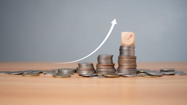 Inflation concept, white graph arrow, world economics, and inflation control, Money and budget management, dart board on a wooden cube with row of coins in idea for FED consider interest rate hike.