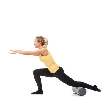 Woman, foam roller and stretching body in studio with lunge exercise, fitness and yoga workout on white background. Pilates, profile and agile lady balance on tube for training, strong core and power.