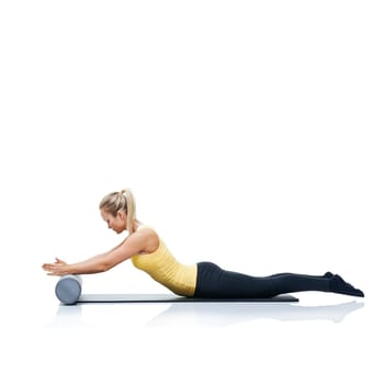 Pilates, foam roller and woman in a studio for workout, stretching or gym routine with yoga mat. Stability, balance and young female athlete from Australia with body exercise by white background