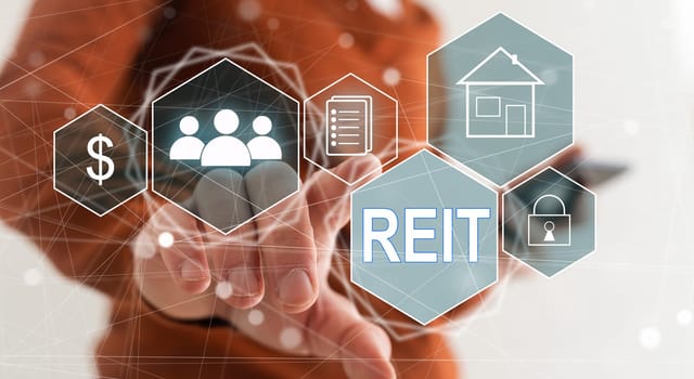 REIT, Real Estate Investment Trust concept, Person hand using smart phone with Real Estate Investment Trust icon on virtual screen