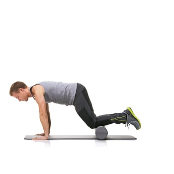 Pilates, foam roller and man in a studio for exercise, stretching or gym routine with yoga mat. Stability, balance and young male athlete from Australia with body workout by white background