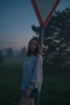 Woman in a field with misty fog