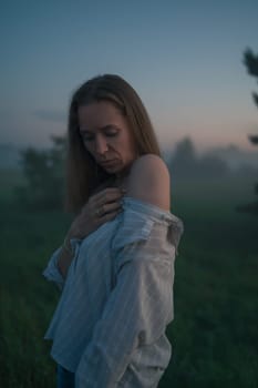 Woman in a field with misty fog