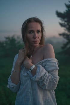 Woman in a field with misty fog