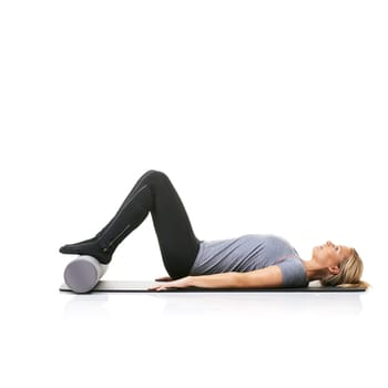 Floor exercise, foam roller and studio woman workout for active lifestyle, gym pilates and rest after fitness routine. Ground, mockup space and girl body development on yoga mat on white background.