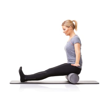 Pilates, foam roller and woman in a studio for exercise, stretching or gym routine with yoga mat. Stability, balance and young female athlete from Australia with body workout by white background