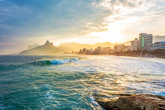 Sunset on Ipanema beach in the city of Rio de Janeiro with the mountains in the background