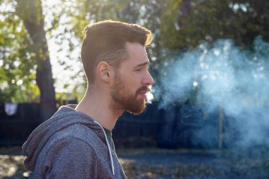 Stylish Man in a Grey Sweatshirt, portrait of a young millennial with a beard.