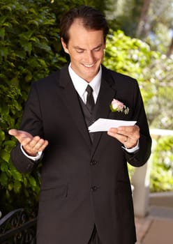 Man, vows and outdoor at wedding ceremony for marriage commitment, promise speech or romance party. Male person, paper and reading as groom for partnership celebration, relationship trust or love.