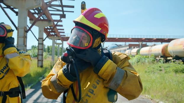 Fire safety exercises. Clip. Men in special uniforms and gas masks conduct rescue exercises on the street. High quality FullHD footage