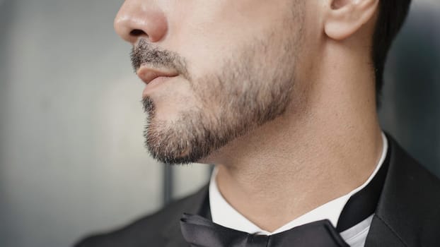 Close-up of man in elegant suit with bow tie. Action. Man in suit for event. Man with elegant suit and bow tie.