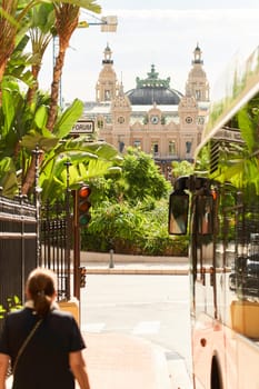 Monaco, Monte-Carlo, 21 October 2022 - Square Casino Monte-Carlo at sunny day, wealth life, tourists take pictures of the landmark, pine trees, blue sky. High quality photo